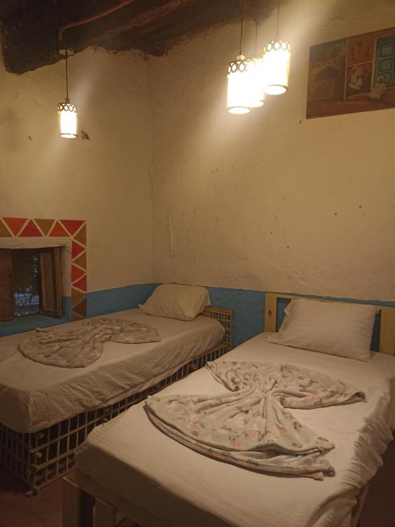 Postel nebo postele na pokoji v ubytování Bait Ward Nubian House