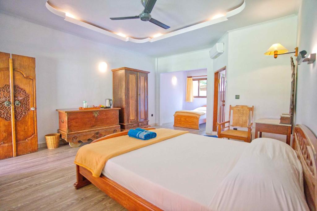 Postel nebo postele na pokoji v ubytování Uns Hotel - Bali