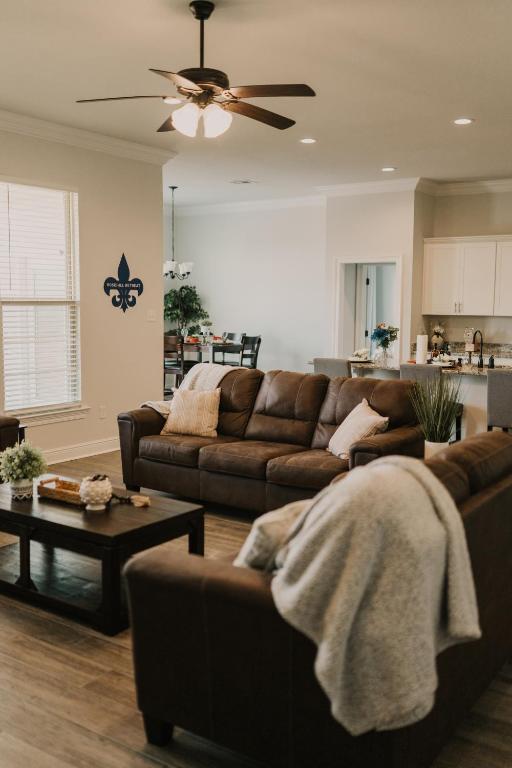 a living room with a couch and a table at Contractor Ready No Penalty Changes Fast Wi-F in Lake Charles
