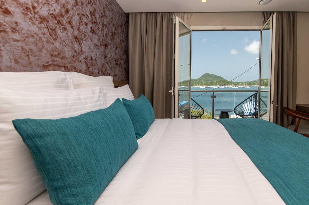 Postel nebo postele na pokoji v ubytování Sable Bleu Boutique Hotel