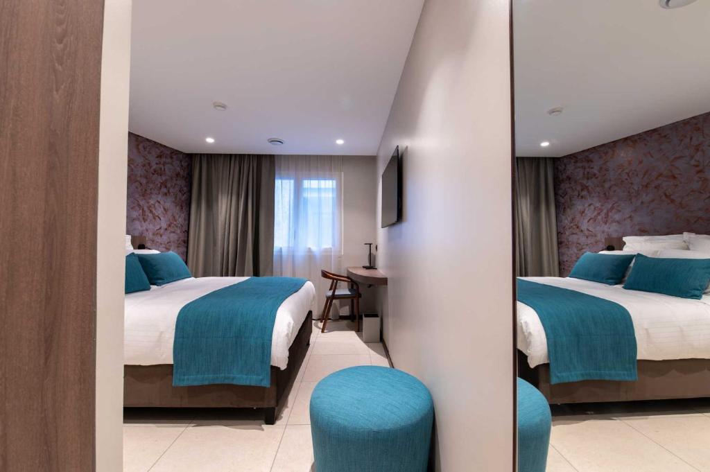 Postel nebo postele na pokoji v ubytování Sable Bleu Boutique Hotel