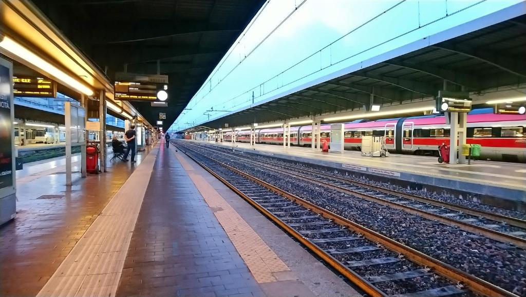 a train station with two trains on the tracks at Ca' Rosso Venice in Venice