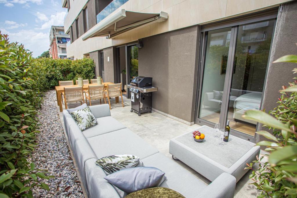 a patio with a white couch and a table at BK Holiday in Rovinj