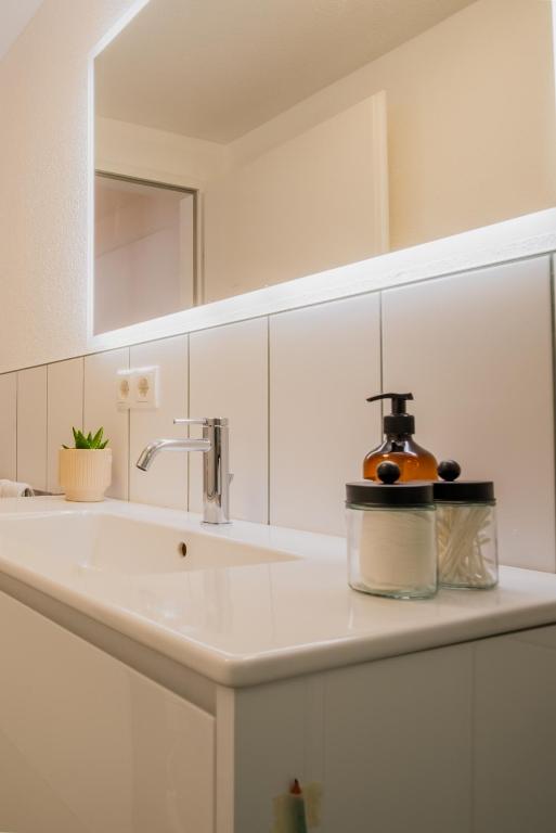 a kitchen counter with a sink with a soap dispenser on it at Noas Jazz in Innsbruck