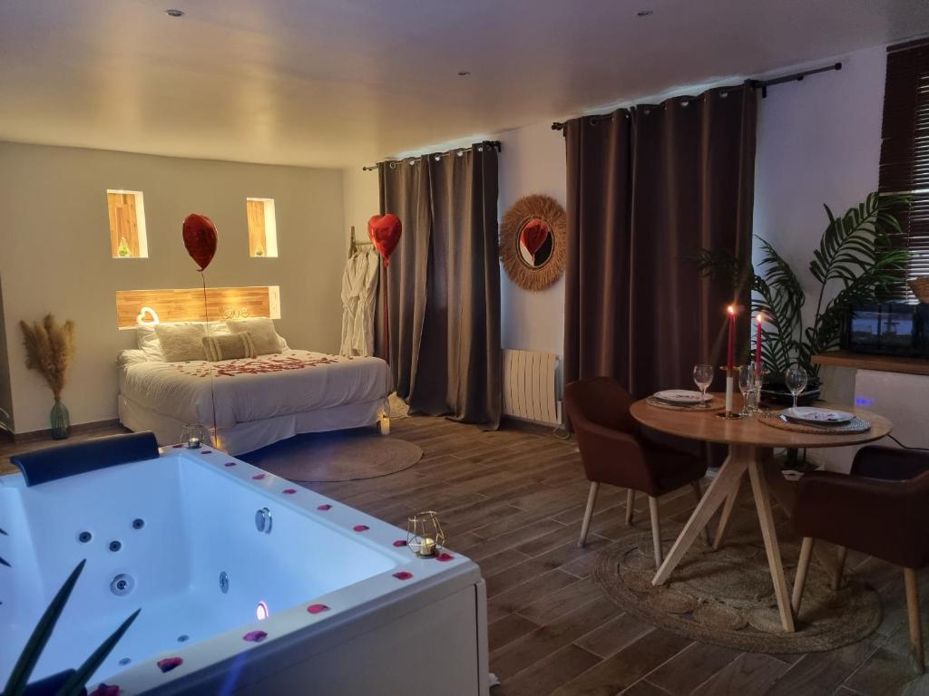 a bedroom with a bed and a pool table at Loft avec jacuzzi illimité et privatif au calme 20 min Paris in Saint-Prix