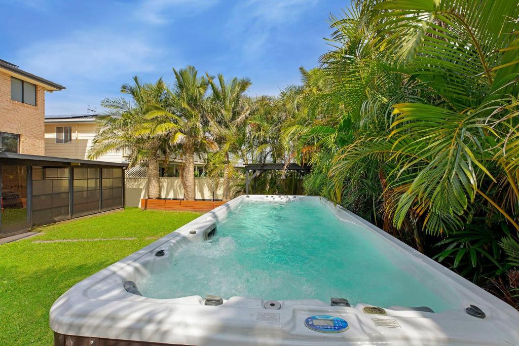 a hot tub in the yard of a house at North Entrance Beach House in The Entrance
