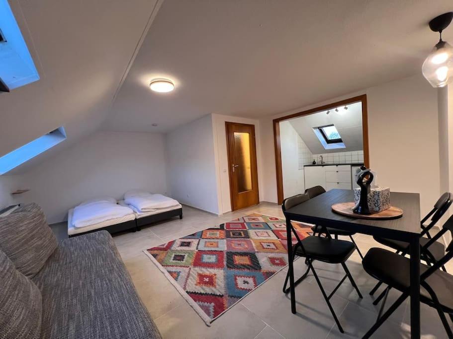 a living room with a table and a bed at City Apartment - Business&Uni - FREE WIFI in Bochum