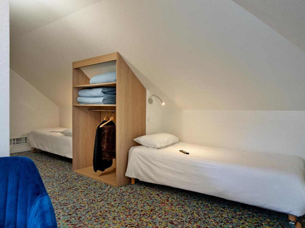 Postel nebo postele na pokoji v ubytování Hôtel REVOTEL Nancy Centre Gare et Congrès