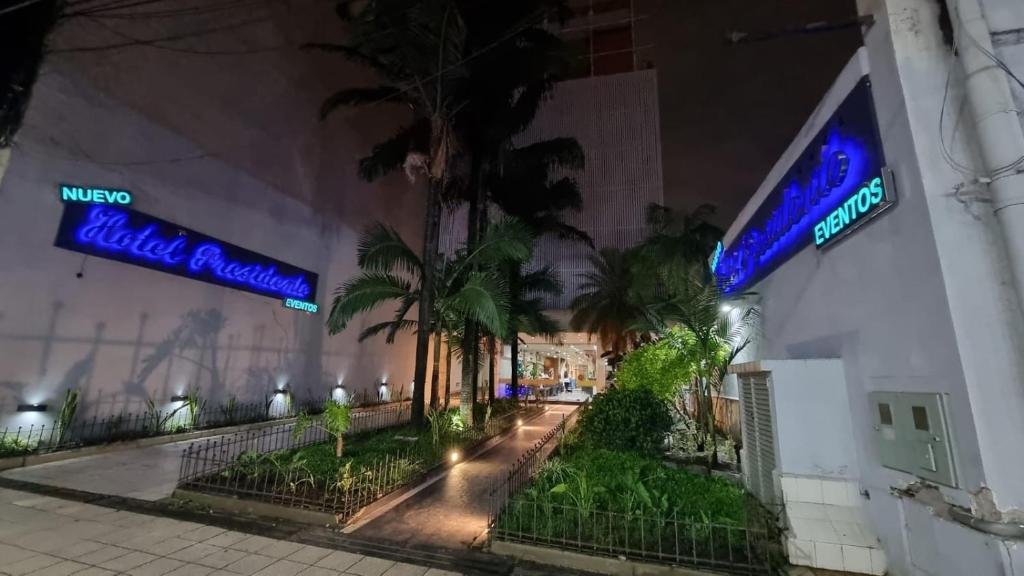 a building with neon signs on the side of it at Hotel Presidente in San Miguel de Tucumán