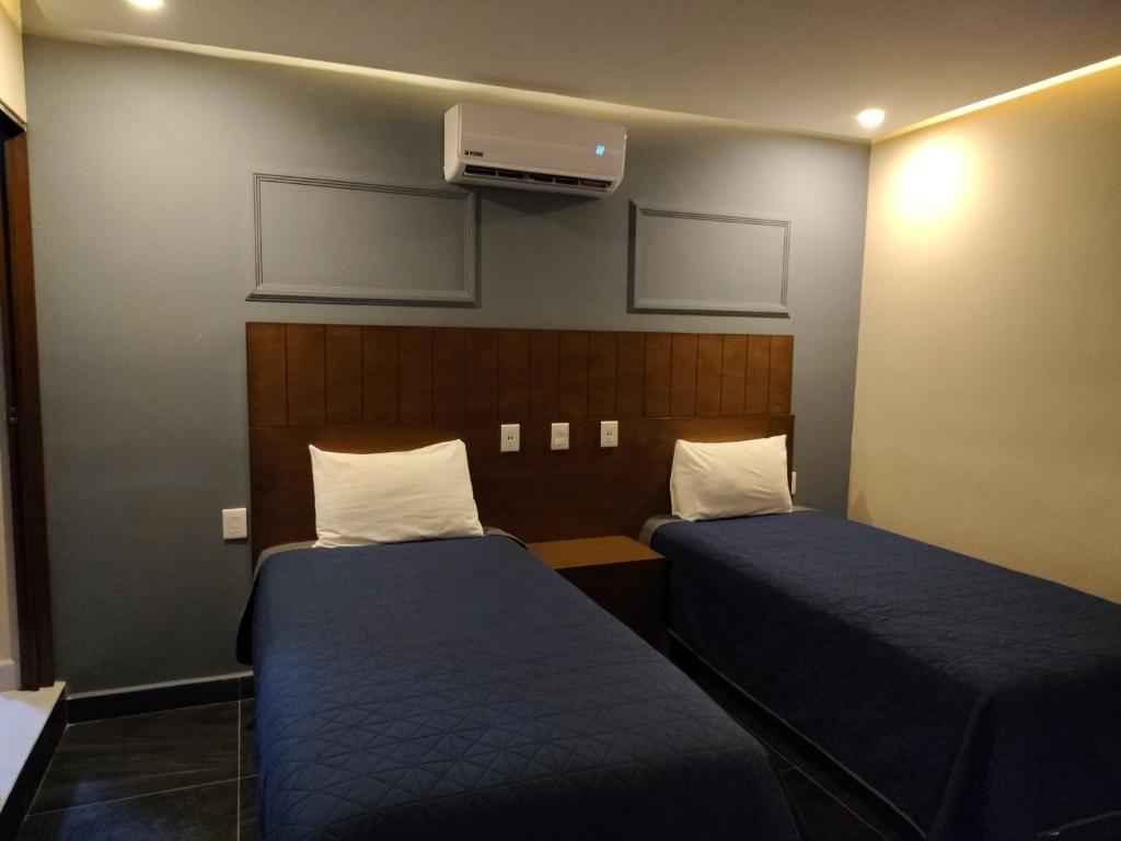 Postel nebo postele na pokoji v ubytování Hotel Casa 20