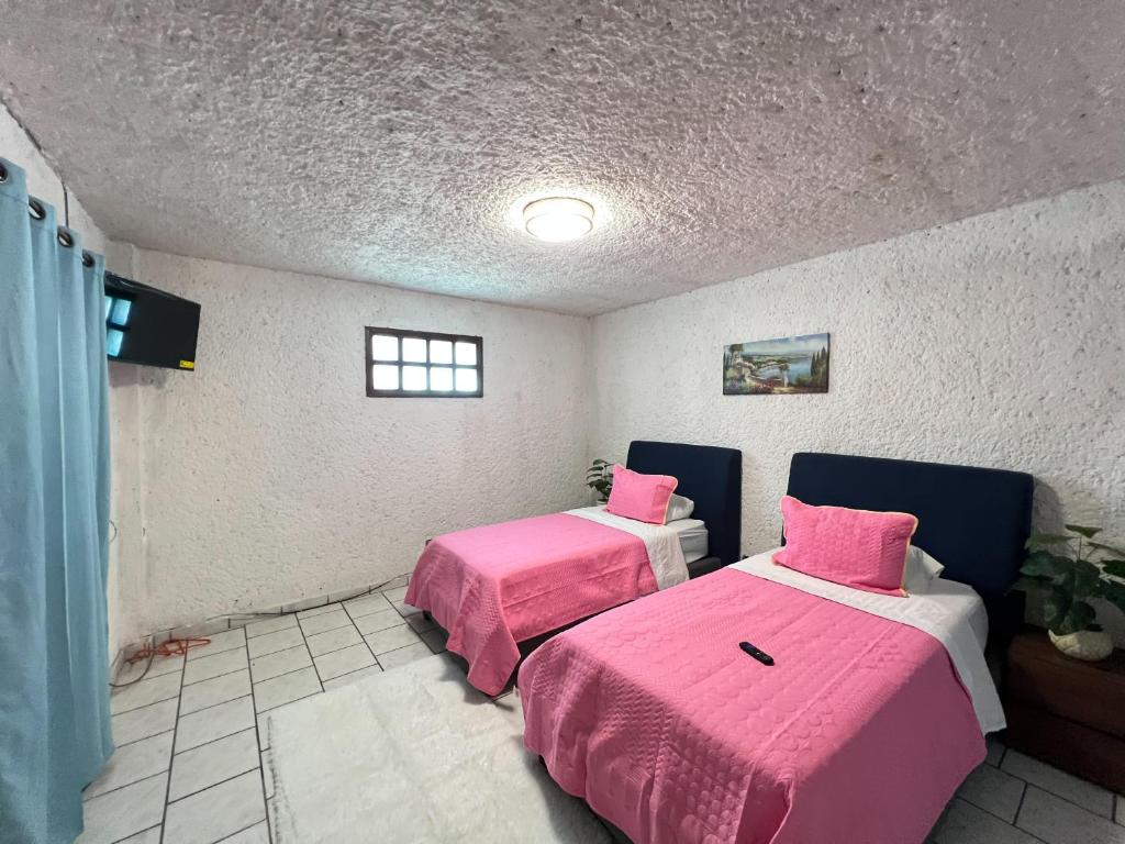 Postel nebo postele na pokoji v ubytování Hotel RJ Querétaro