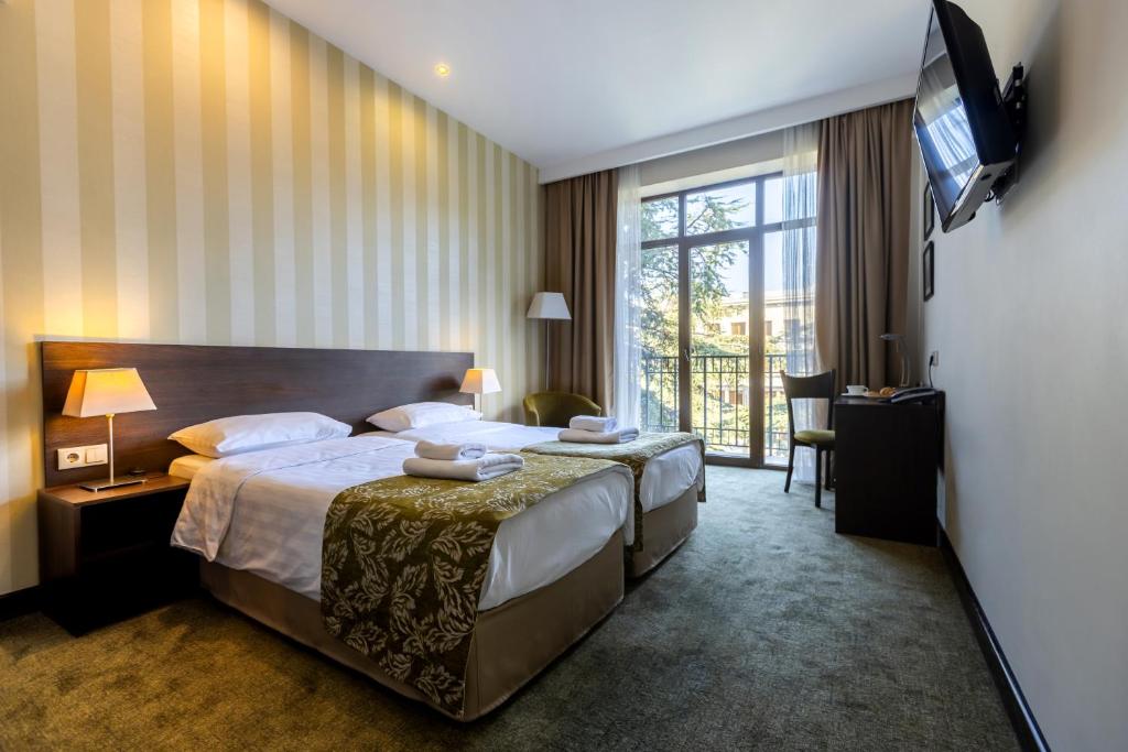 Postel nebo postele na pokoji v ubytování Citrus Hotel