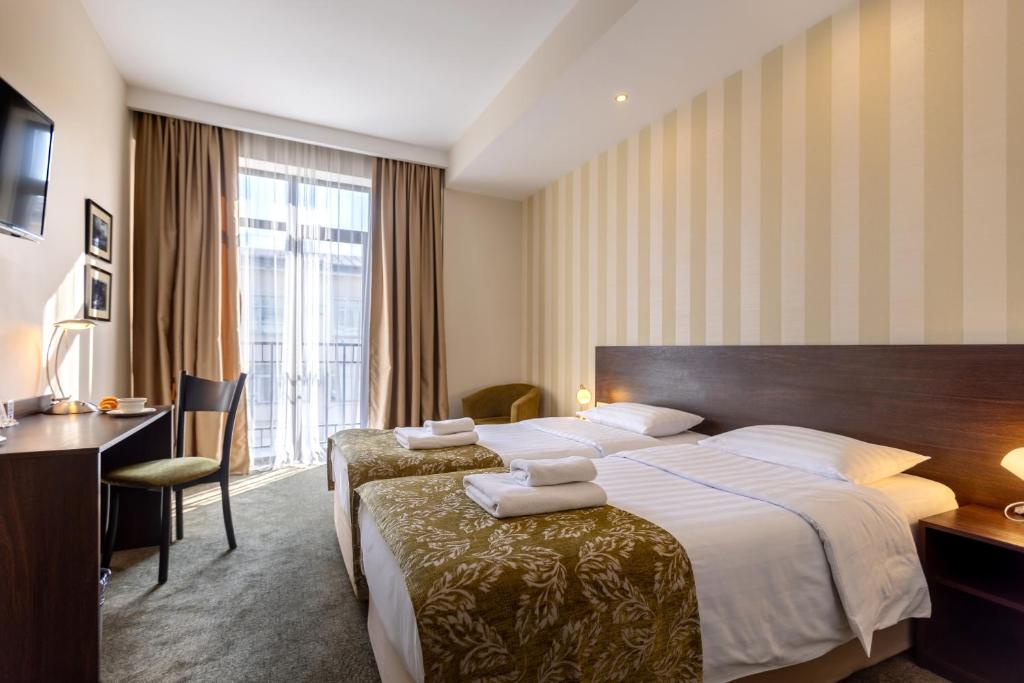Postel nebo postele na pokoji v ubytování Citrus Hotel
