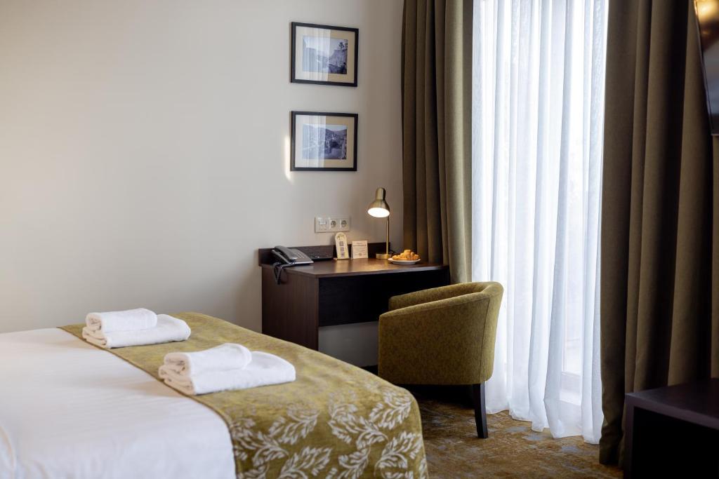 Postel nebo postele na pokoji v ubytování Citrus Hotel