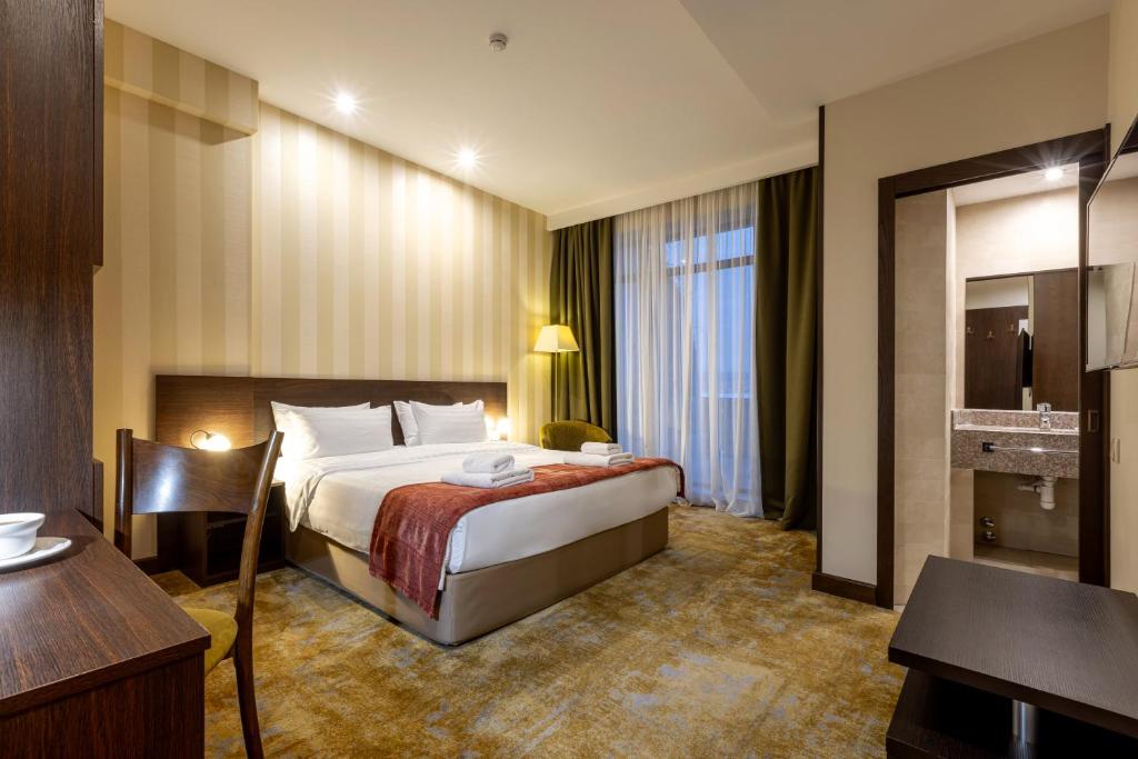 Postel nebo postele na pokoji v ubytování Citrus Hotel
