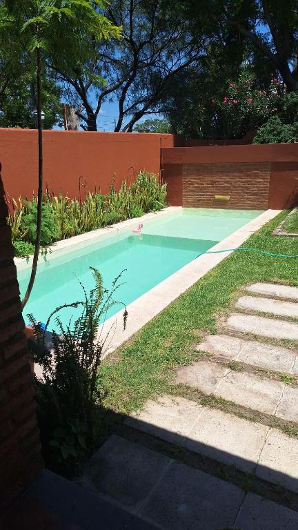 a swimming pool in a yard next to a fence at Aire de campo en la ciudad in San Fernando del Valle de Catamarca