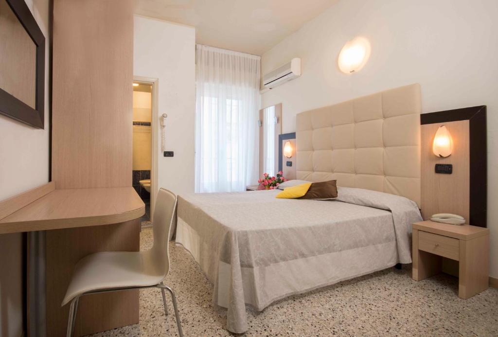 Postel nebo postele na pokoji v ubytování Hotel Veliero