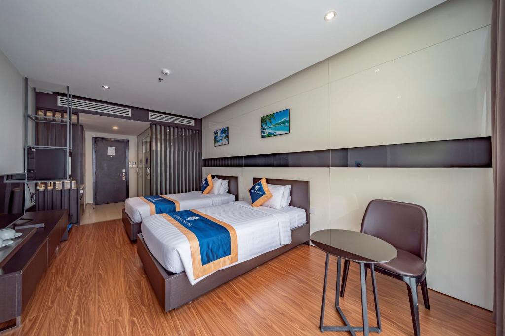 Giường trong phòng chung tại Poseidon Nha Trang Hotel