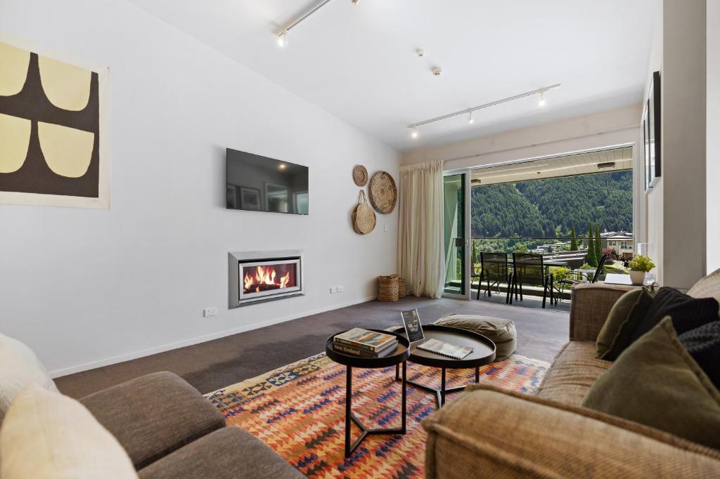 a living room with a couch and a fireplace at Stylish Haven Luxury Interiors in Prime Location in Queenstown