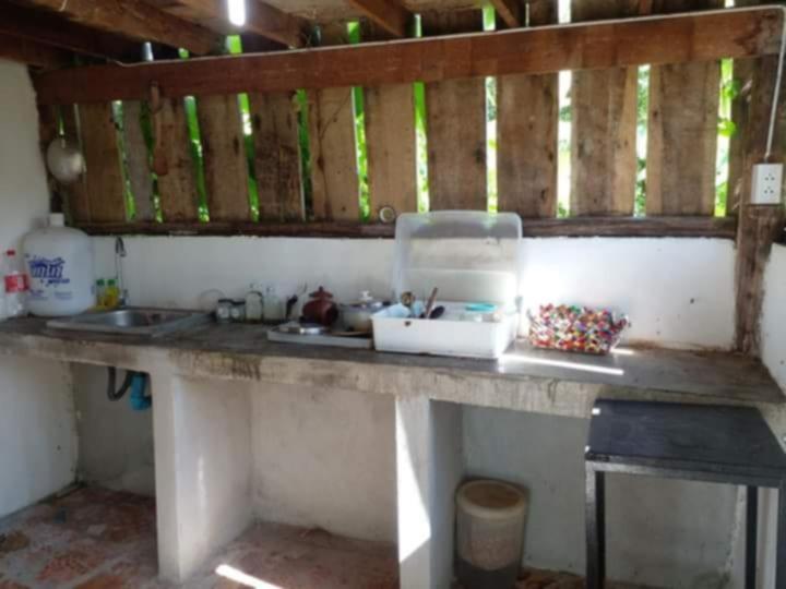 a kitchen with a counter with a sink and a counter at Farmer house on Beverley hill Pai in Pai