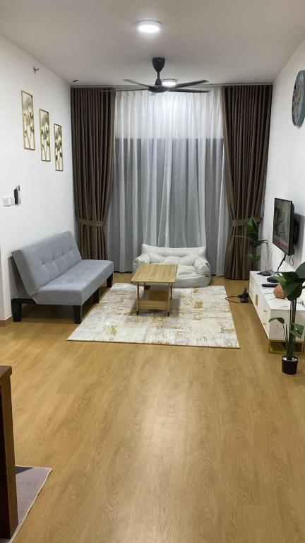 a living room with a couch and a coffee table at Irdina Homestay in Banting