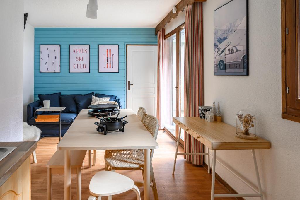 a kitchen and living room with a table and chairs at CozySerenity, Orelle & Les 3 Vallées in Orelle