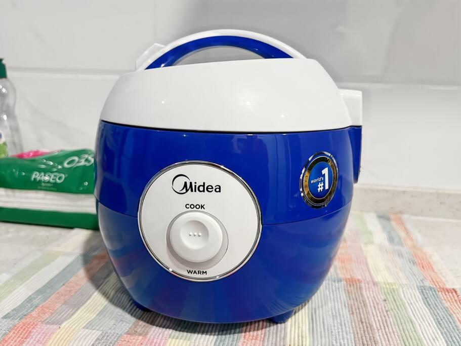 a blue and white toaster sitting on a counter at Cozy Studio Skyhouse Apt near ICE BSD with pool & Gym by 2ndHome in Cilenggang