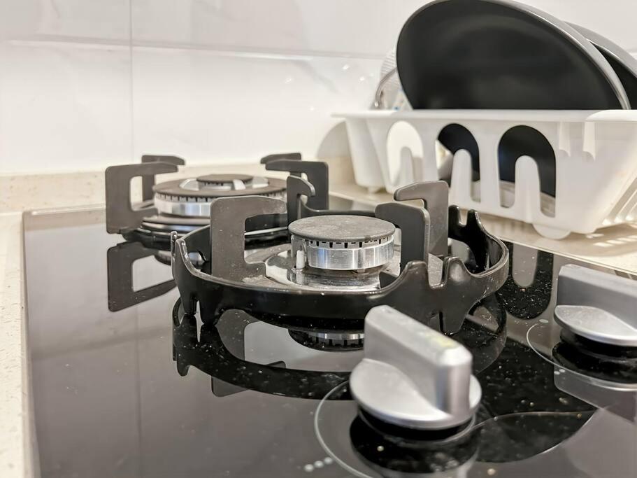 a stove top with a pot on top of it at Cozy Studio Skyhouse Apt near ICE BSD with pool & Gym by 2ndHome in Cilenggang