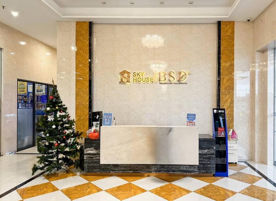 a christmas tree in the lobby of a hotel at Cozy Studio Skyhouse Apt near ICE BSD with pool & Gym by 2ndHome in Cilenggang