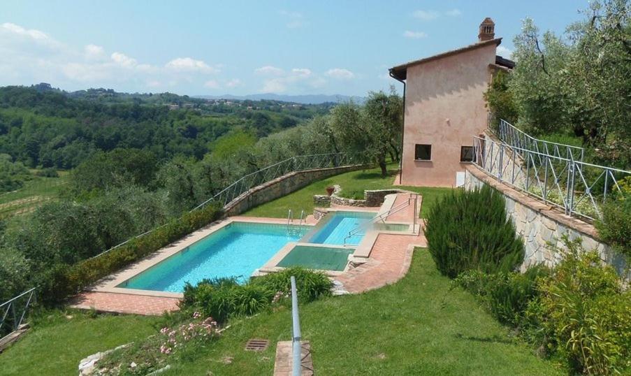 The swimming pool at or close to Villa il Pino by VacaVilla