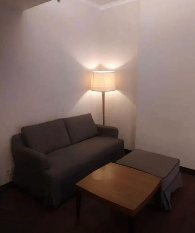 a living room with a couch and a table at Ex Hotel Aston Marina Ancol in Jakarta