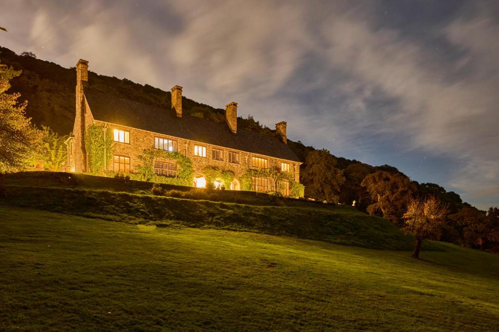 a large building on top of a grass field at Bossington Bunkhouse in Minehead