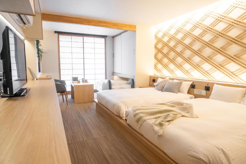 Postel nebo postele na pokoji v ubytování ORI Kyoto