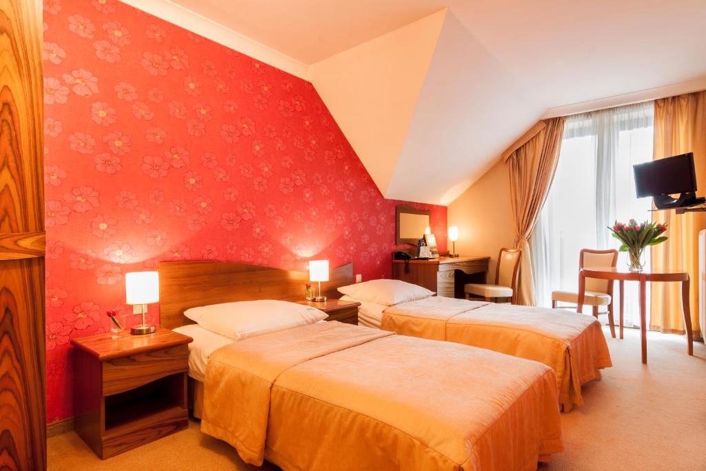 Postel nebo postele na pokoji v ubytování Hotel Fajkier