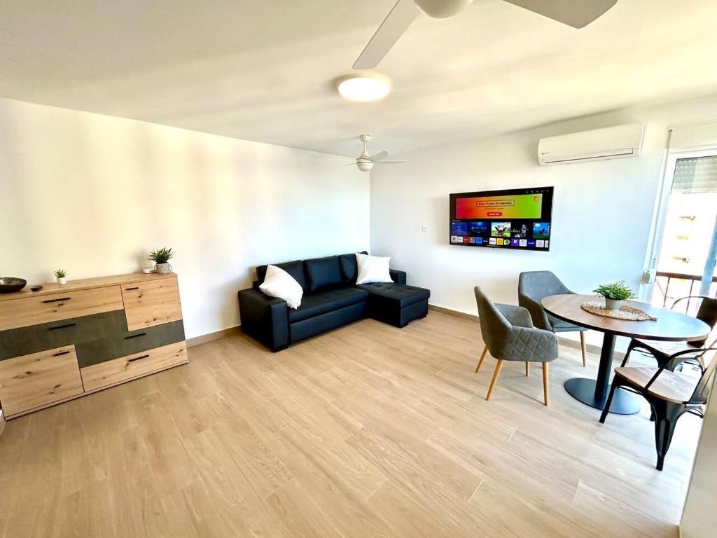 a living room with a couch and a table at Campoamor - Más que apartamentos in Dehesa de Campoamor