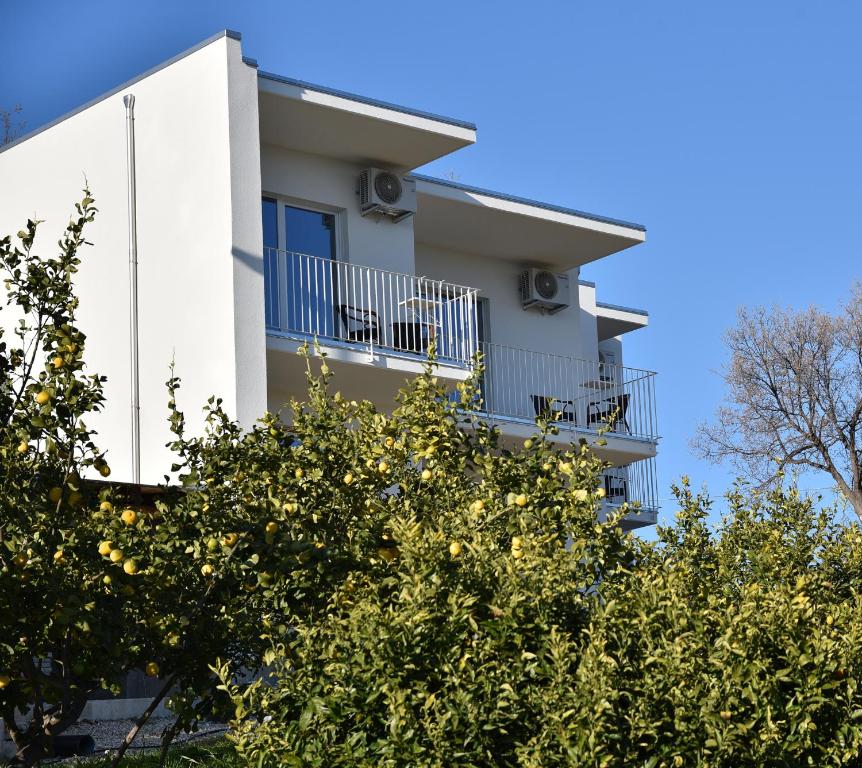 a white building with trees in front of it at Villa Caravaggio Comfort e Relax in Rocca San Giovanni