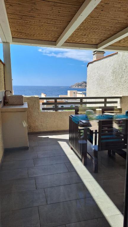 a patio with a table and a view of the ocean at Appartamento vista mare in Santa Teresa Gallura