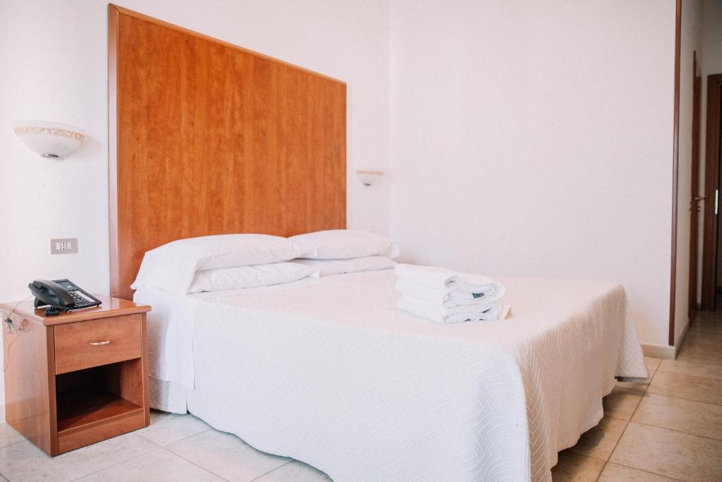 Postel nebo postele na pokoji v ubytování Magnolia Hotel Vieste