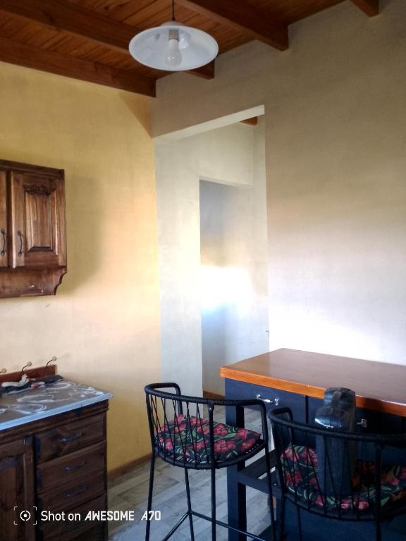 a kitchen with two chairs and a counter top at Lo de tina in Florencio Varela