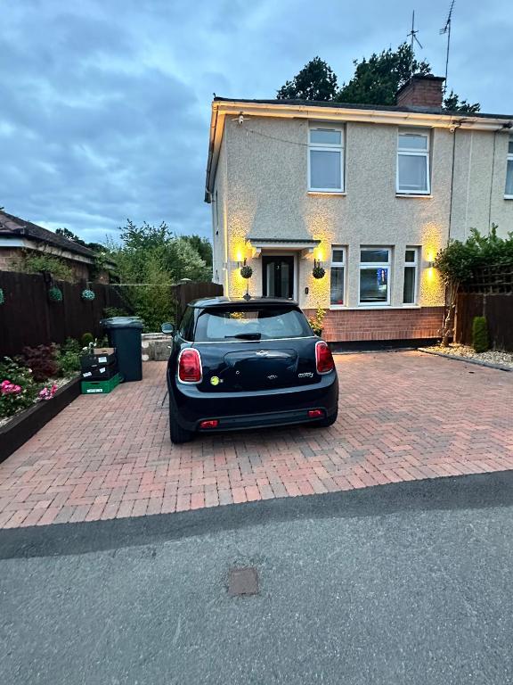 a black car parked in front of a house at Room to Rent in Worcester