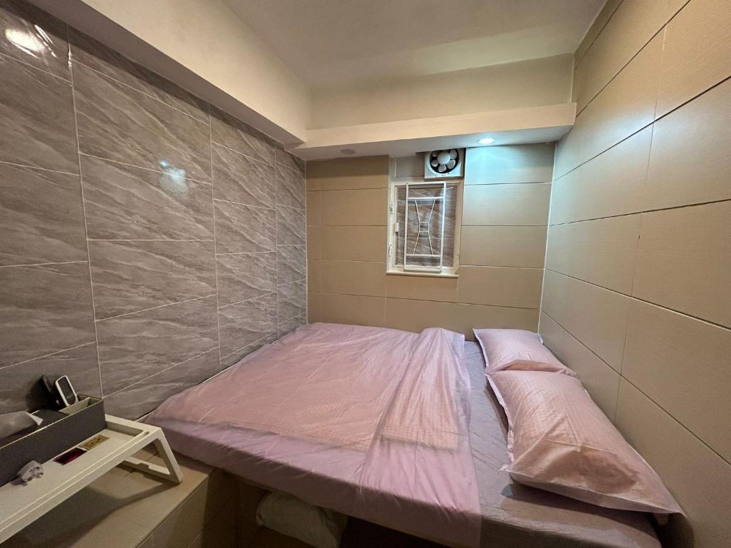Postel nebo postele na pokoji v ubytování 奧地利賓館 Chill House Motel