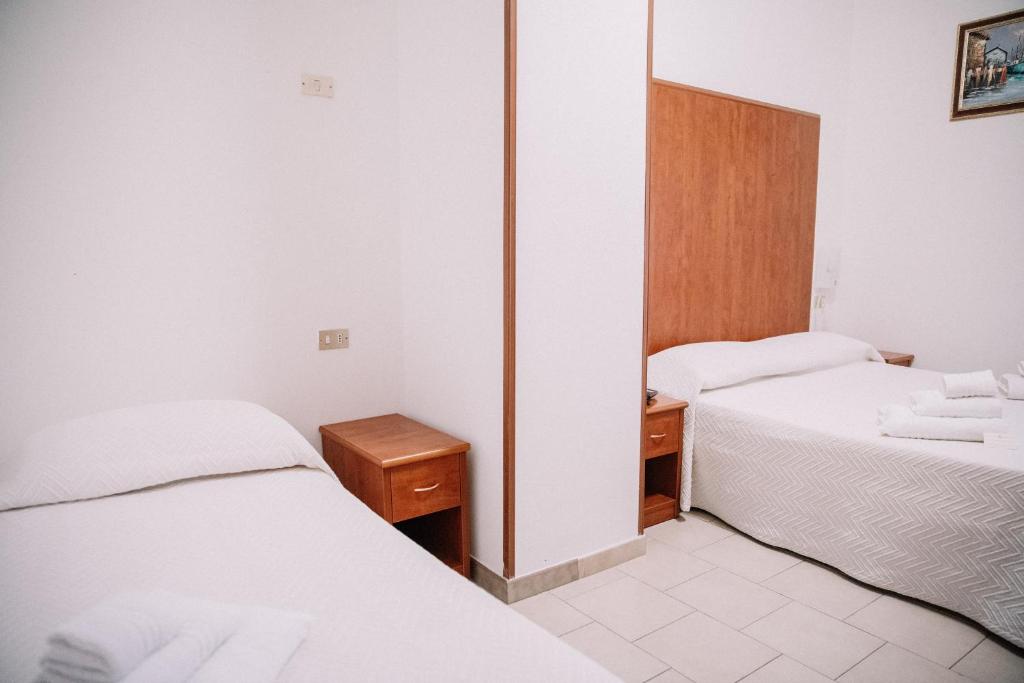 Postel nebo postele na pokoji v ubytování Magnolia Hotel Vieste