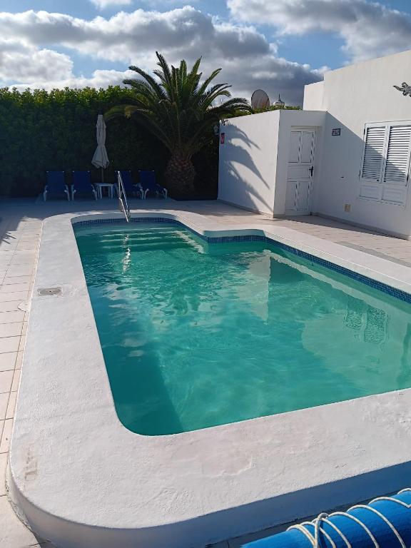 a swimming pool in front of a house at Casa Jaime in Puerto del Carmen