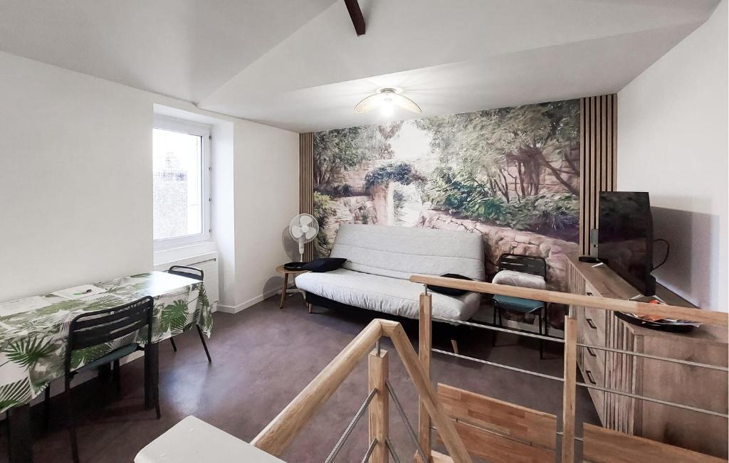 a living room with a couch and a painting on the wall at Beautiful Apartment With Wifi in Pornic