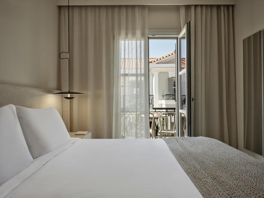 Postel nebo postele na pokoji v ubytování Doryssa Method Hotel