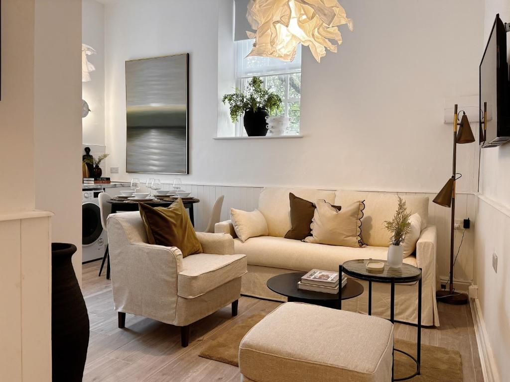 a living room with a couch and a table at Central Todmorden 2 Bedroom Apartment in Todmorden