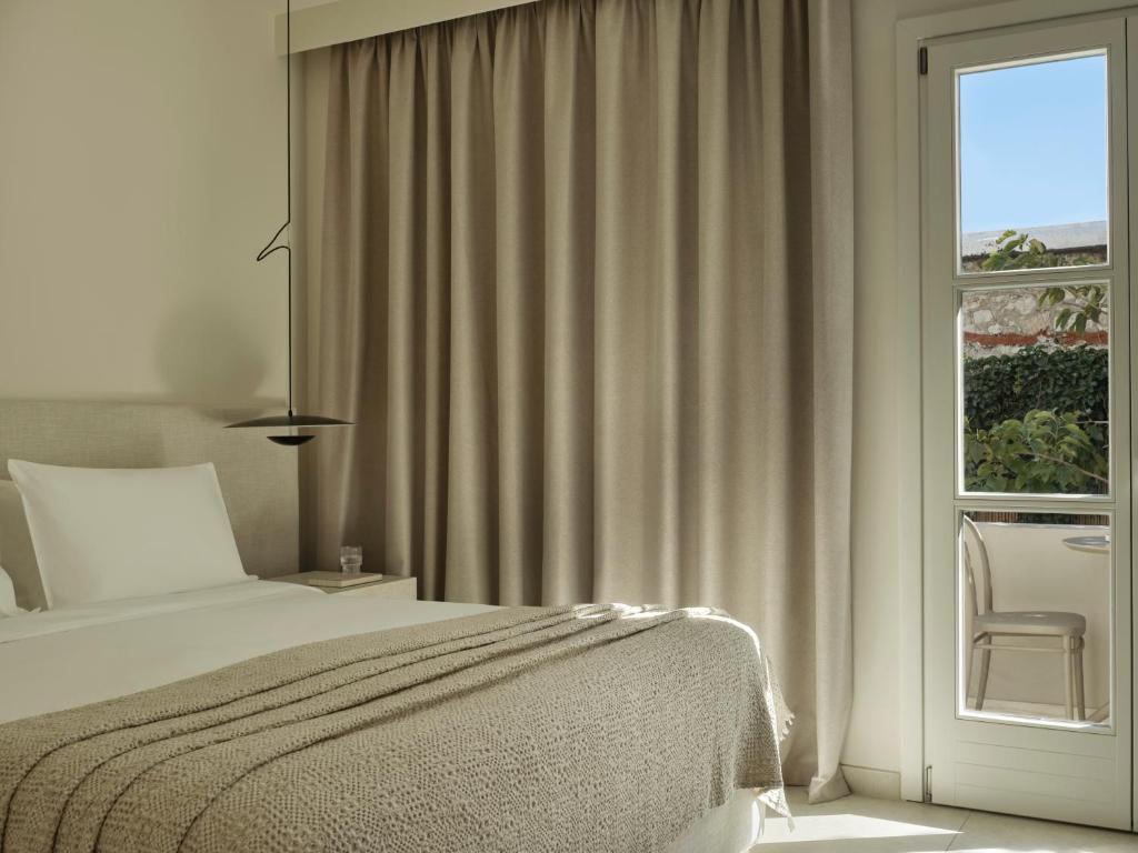 Postel nebo postele na pokoji v ubytování Doryssa Method Hotel