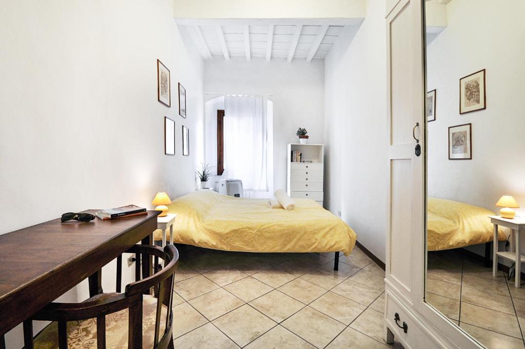 a bedroom with a bed and a desk in a room at Castellani Apartment in Florence