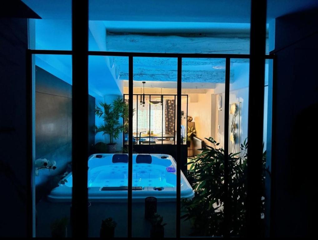 a room with a view of a swimming pool at night at Sweet dream in Pignans