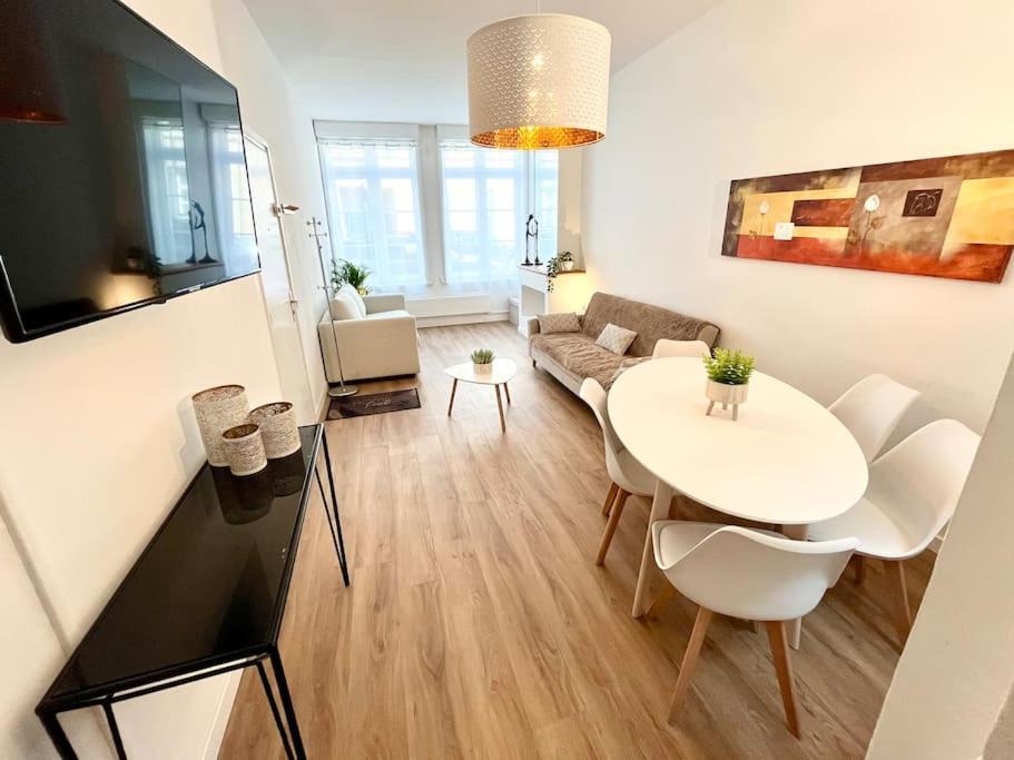a living room with a white table and a couch at Joli appartement avec cachet dans le Vieux Lille in Lille